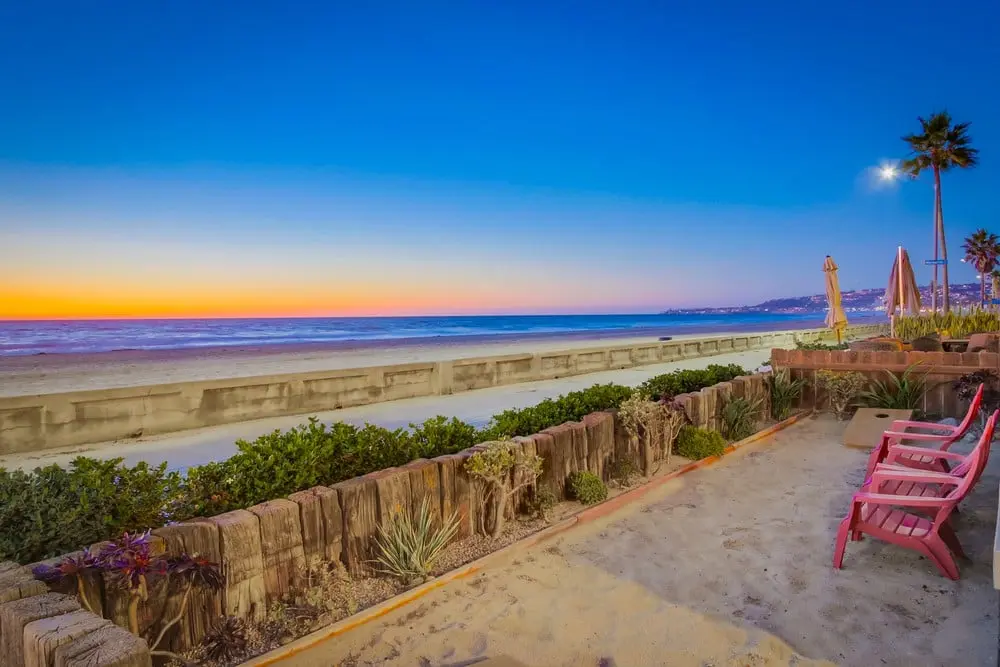 Oceanfront patio at Isurus Beach House during sunset